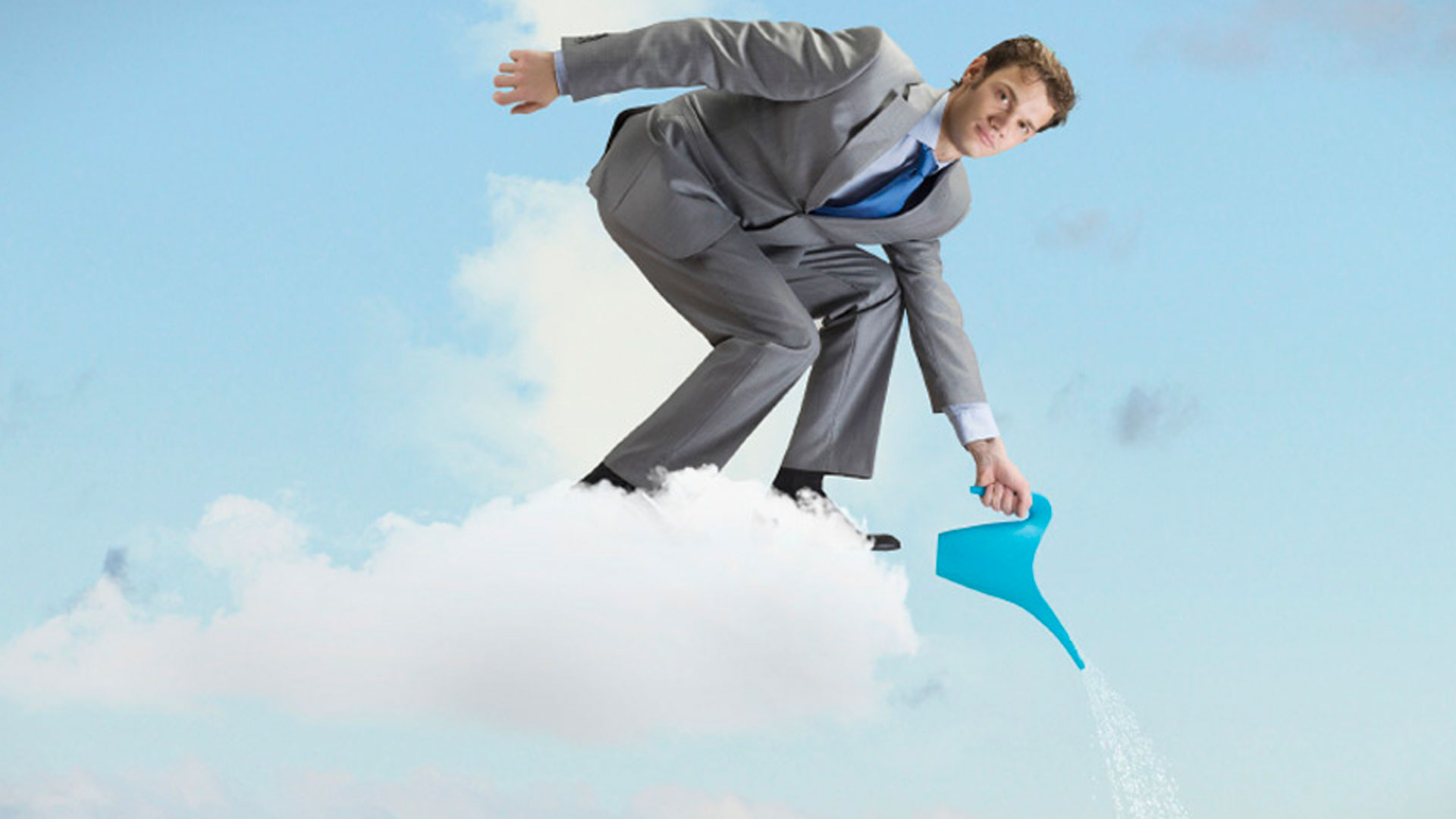 Man standing on a cloud watering